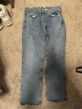 AGOLDE med/high rise straight jeans in a light to medium blue wash.